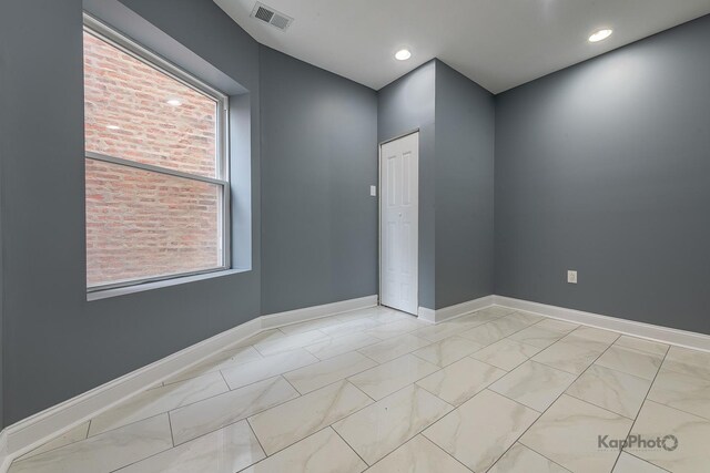 unfurnished room featuring visible vents, marble finish floor, baseboards, and recessed lighting