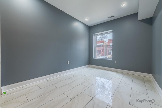 spare room featuring baseboards, recessed lighting, and visible vents