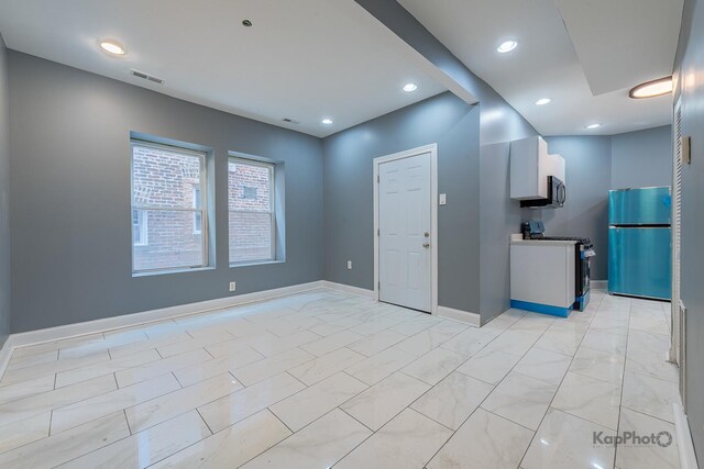 empty room with baseboards, recessed lighting, and visible vents