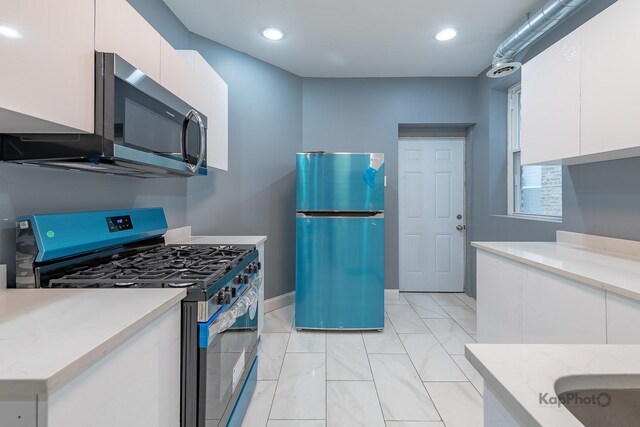 kitchen with white cabinets, light stone countertops, appliances with stainless steel finishes, recessed lighting, and modern cabinets