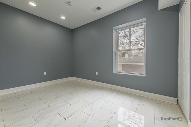 unfurnished room featuring visible vents, recessed lighting, baseboards, and marble finish floor