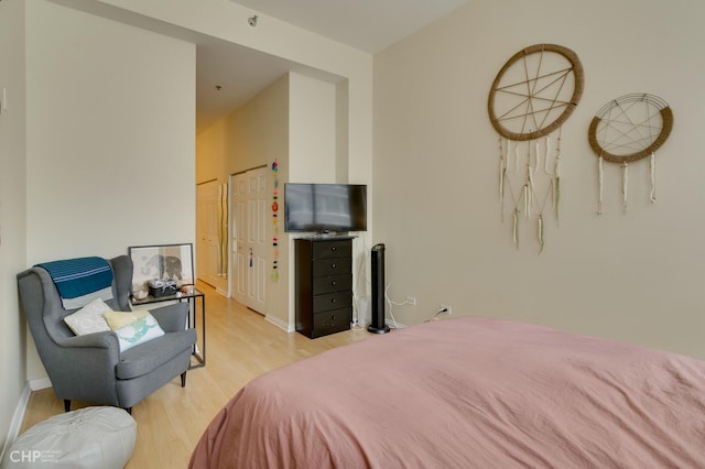 bedroom with baseboards and light wood finished floors