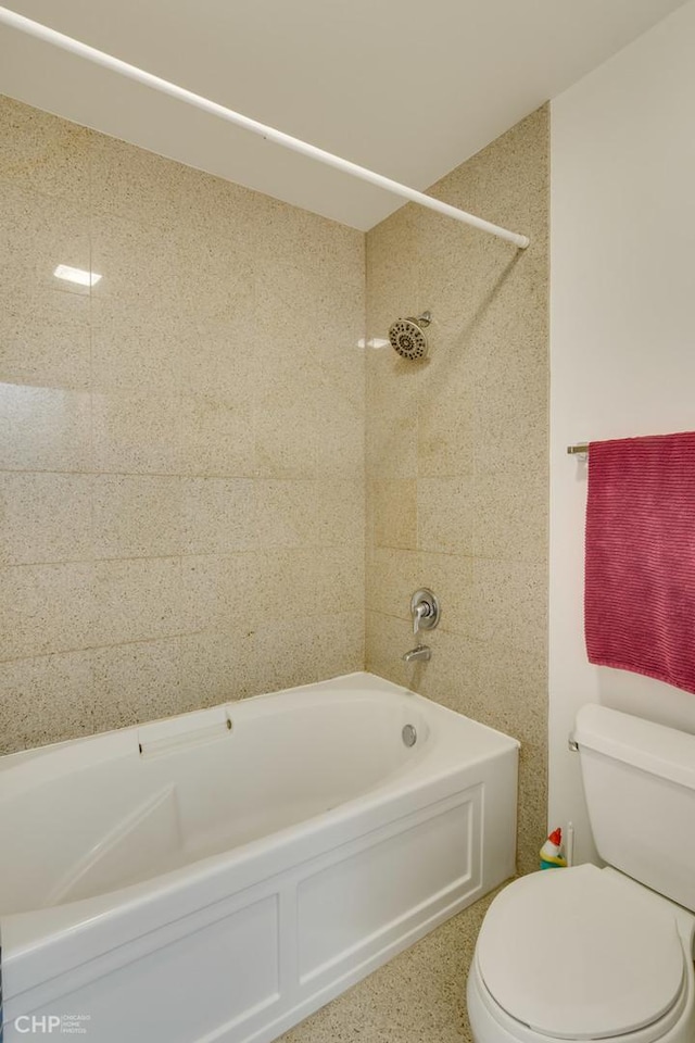 bathroom featuring shower / tub combination and toilet