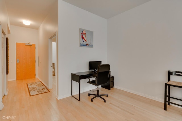 home office with baseboards and wood finished floors