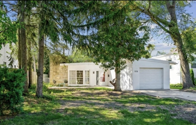 1578 Mccraren Rd, Highland Park, IL 60035 - view of front of house featuring a garage, driveway, and stucco siding