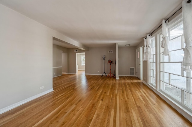 1578 Mccraren Rd, Highland Park, IL 60035 - unfurnished living room with light wood finished floors and baseboards