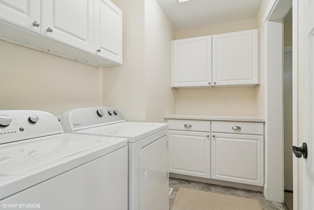 washroom featuring cabinet space and independent washer and dryer