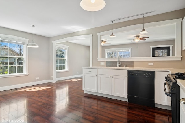 kitchen with light countertops, ceiling fan, black appliances, and a healthy amount of sunlight
