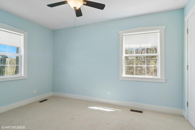 spare room featuring visible vents, carpet, and ceiling fan