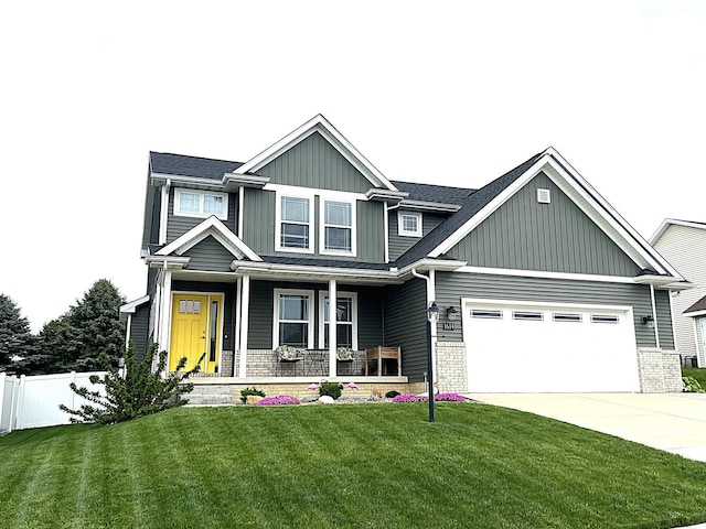 1614 Oliger Dr, Mahomet, IL 61853 - craftsman-style house with a porch, board and batten siding, driveway, fence, and a front lawn