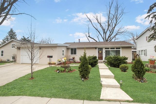 ranch-style house with concrete driveway, an attached garage, and a front lawn