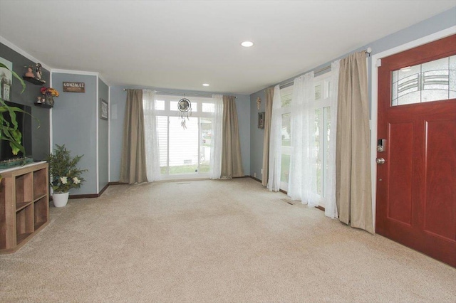 foyer entrance with baseboards, carpet flooring, and recessed lighting