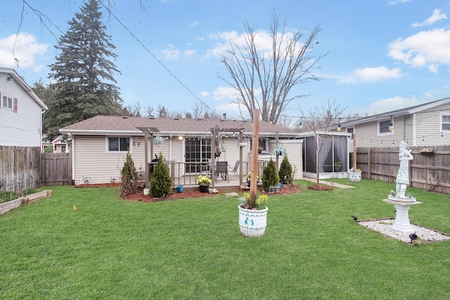 rear view of property featuring a lawn, a patio, a fenced backyard, and a sunroom