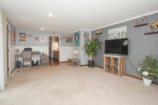 living area featuring recessed lighting, baseboards, carpet, and a wainscoted wall