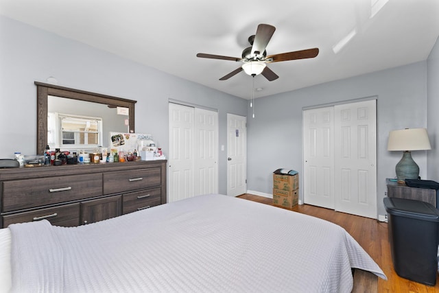 2642 N Harlem Ave Unit 2W, Elmwood Park, IL 60707 - bedroom featuring baseboards, multiple closets, ceiling fan, and wood finished floors