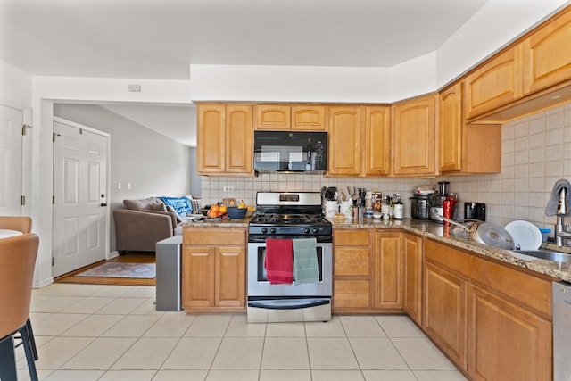 2642 N Harlem Ave Unit 2W, Elmwood Park, IL 60707 - kitchen featuring appliances with stainless steel finishes, stone countertops, backsplash, and light tile patterned flooring