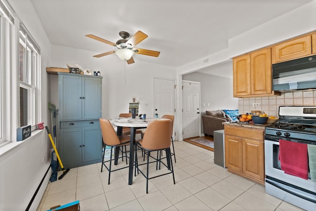 2642 N Harlem Ave Unit 2W, Elmwood Park, IL 60707 - kitchen with decorative backsplash, ceiling fan, gas range, black microwave, and a baseboard heating unit