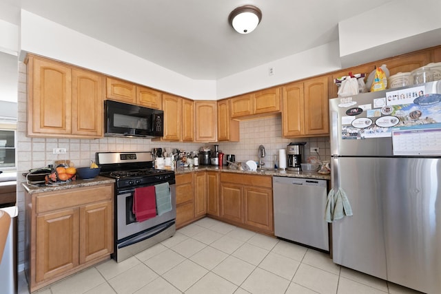 2642 N Harlem Ave Unit 2W, Elmwood Park, IL 60707 - kitchen with light stone countertops, appliances with stainless steel finishes, a sink, light tile patterned floors, and tasteful backsplash