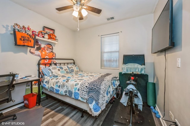 bedroom featuring visible vents, ceiling fan, and wood finished floors