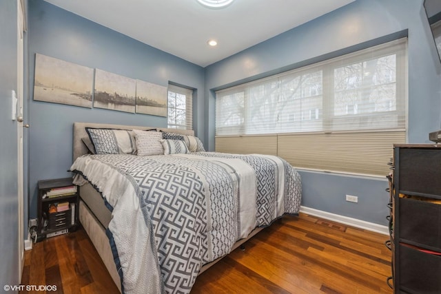 bedroom featuring baseboards and wood finished floors