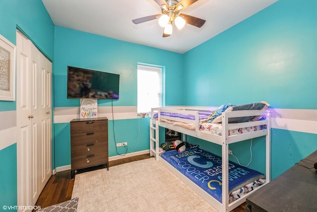 bedroom featuring ceiling fan, a closet, and wood finished floors