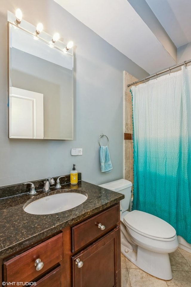 bathroom with tile patterned flooring, a shower with shower curtain, toilet, and vanity