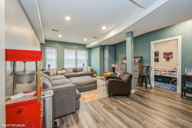 living room with baseboards, recessed lighting, wood finished floors, and visible vents