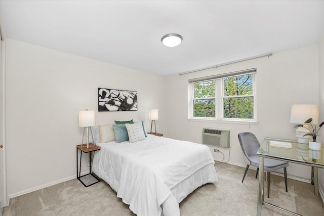 bedroom with baseboards, light carpet, and an AC wall unit