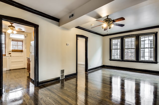spare room featuring ornamental molding, a ceiling fan, wood finished floors, and visible vents