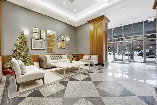 building lobby with recessed lighting, wainscoting, and crown molding