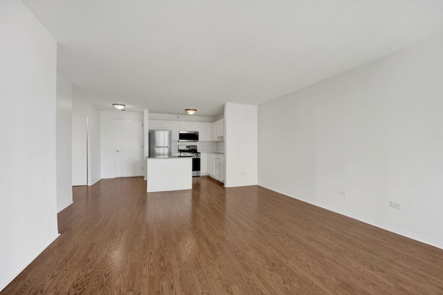 unfurnished living room with dark wood finished floors and baseboards