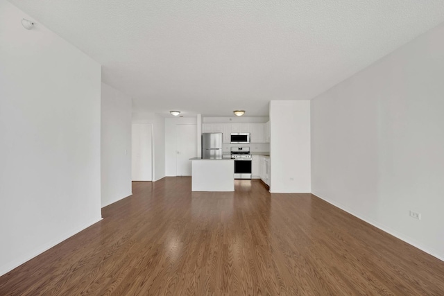 unfurnished living room with dark wood finished floors and baseboards