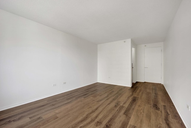 unfurnished room featuring wood finished floors and baseboards