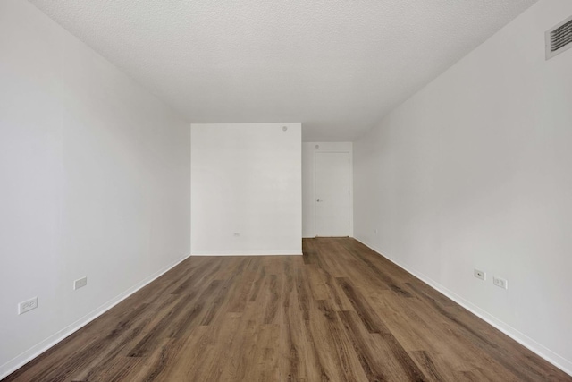unfurnished room with wood finished floors and baseboards