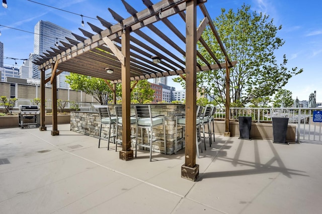 view of patio with a pergola and a grill