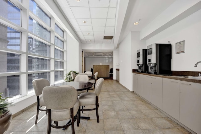 dining area featuring a drop ceiling