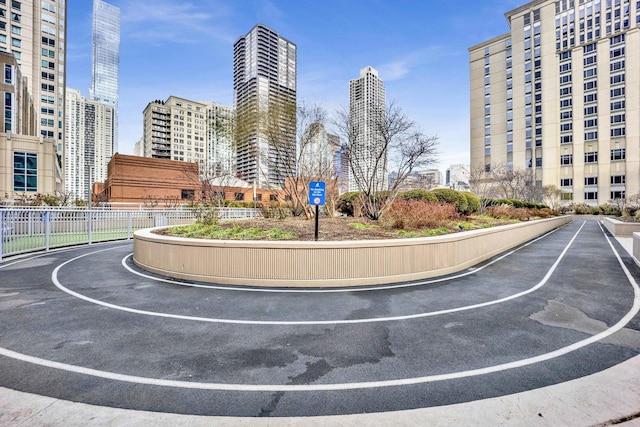 surrounding community featuring a view of city and fence