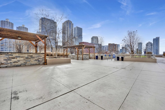 view of property's community featuring a view of skyline and a pergola