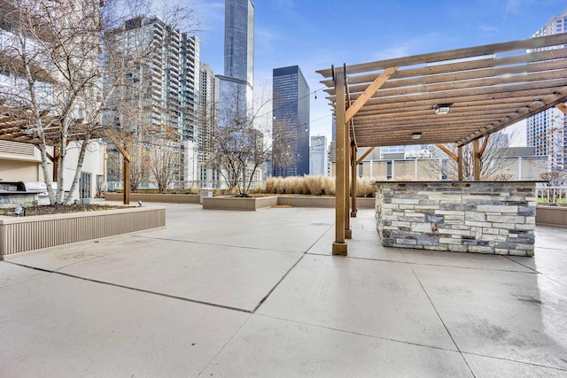 view of home's community with a pergola, a patio area, and a city view