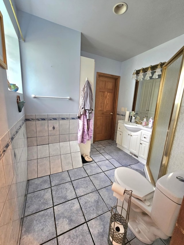 bathroom featuring tile patterned flooring, toilet, and vanity