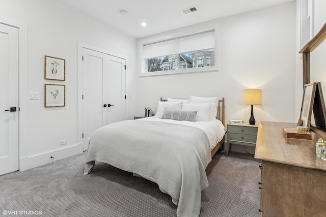 carpeted bedroom with visible vents, recessed lighting, baseboards, and a closet