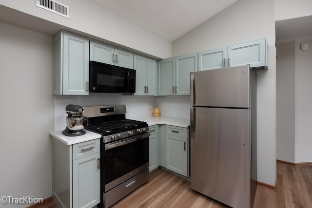 kitchen featuring light countertops, appliances with stainless steel finishes, visible vents, and light wood-style floors