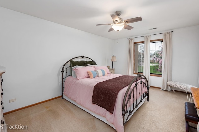 carpeted bedroom featuring visible vents, baseboards, and ceiling fan