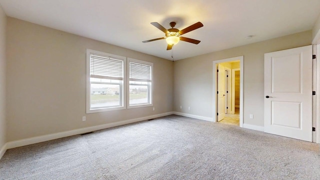 unfurnished bedroom featuring carpet flooring, a ceiling fan, baseboards, and visible vents