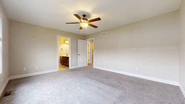empty room with a ceiling fan, baseboards, visible vents, and light carpet