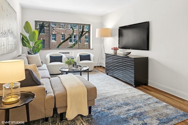 living area featuring baseboards and wood finished floors