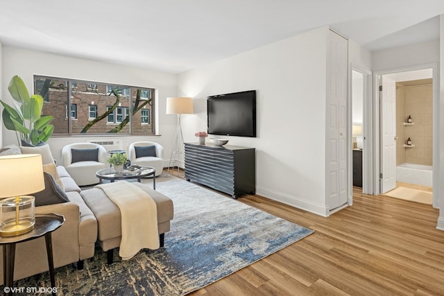 living room featuring baseboards and wood finished floors