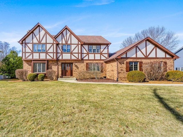 tudor house with brick siding and a front lawn