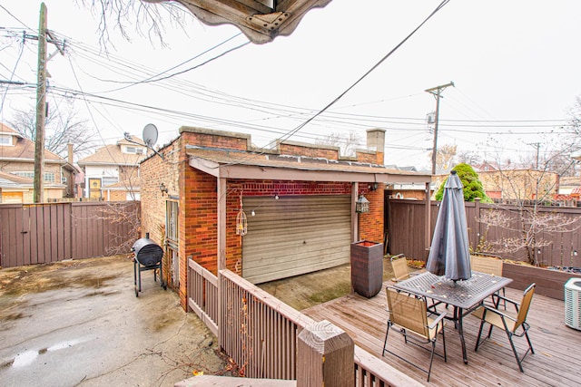 8240 S Champlain Ave, Chicago, IL 60619 - wooden terrace with outdoor dining space and a fenced backyard
