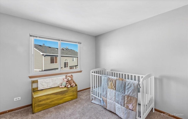 carpeted bedroom featuring baseboards